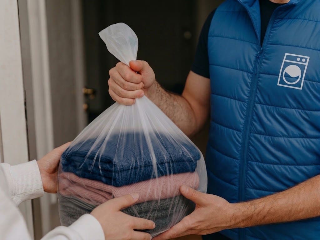 Folded household laundry and clean towels ready for delivery around Tower Park